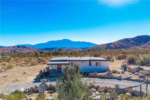 a view of a house with a yard and a mountain view