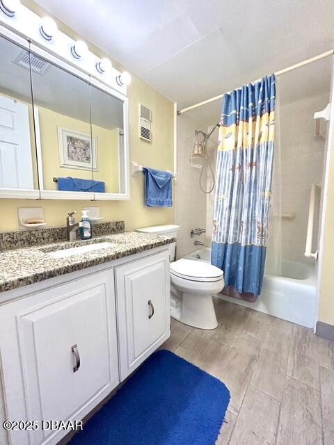 1415 Ocean Shore Drive, Unit 1011 Ormond Beach, FL 32176 - Photo 16 of 20 a bathroom with a granite countertop sink mirror vanity and toilet