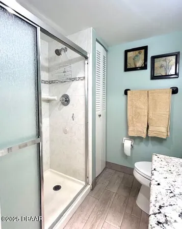 a bathroom with a shower and a toilet