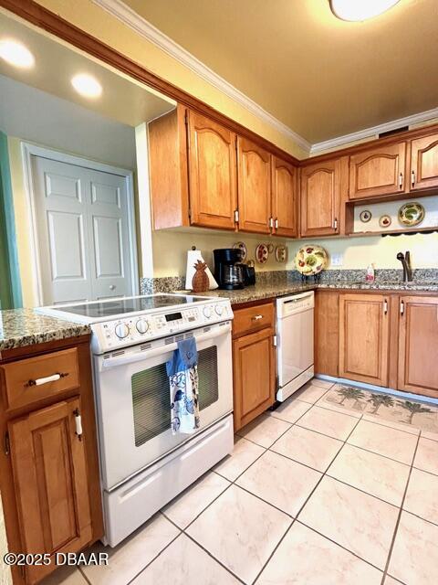 1415 Ocean Shore Drive, Unit 1011 Ormond Beach, FL 32176 - Photo 9 of 20 a kitchen with stainless steel appliances granite countertop a stove a sink and a microwave