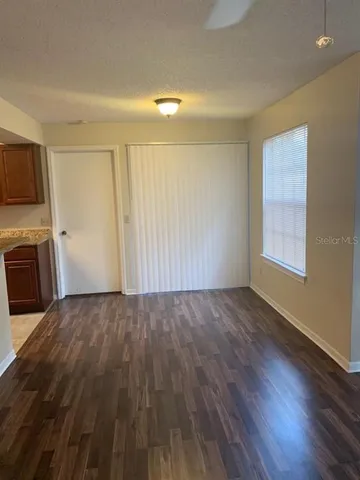 a view of a kitchen with wooden floor and a sink