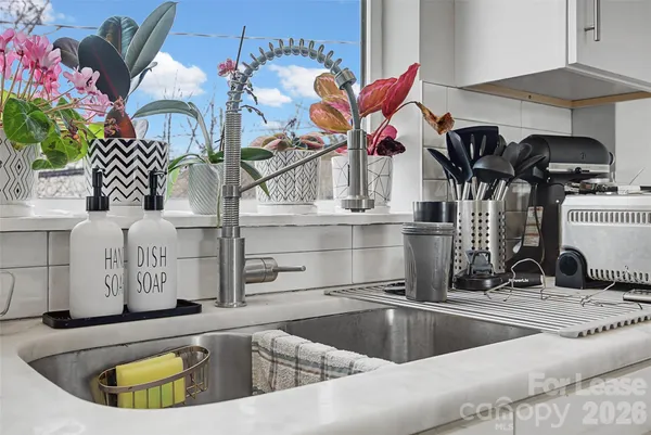 a view of a kitchen with a sink and furniture