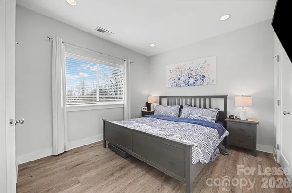 a bedroom with a large bed and a window
