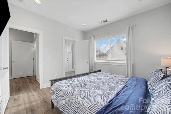 a bedroom with a large bed and a window