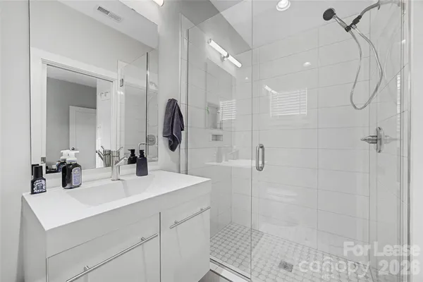 a bathroom with a sink double vanity and shower