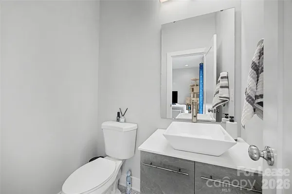 a bathroom with a sink toilet and mirror