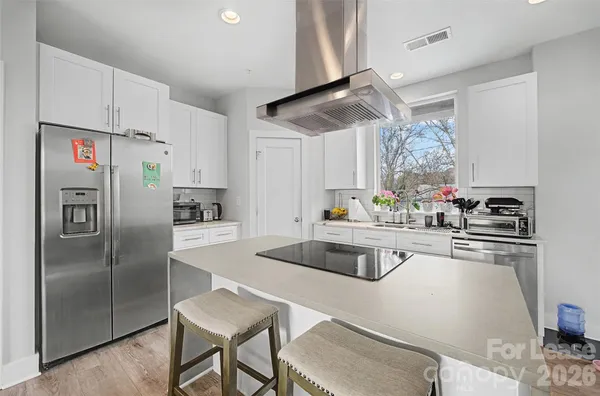 a kitchen with stainless steel appliances granite countertop a sink a stove and a refrigerator