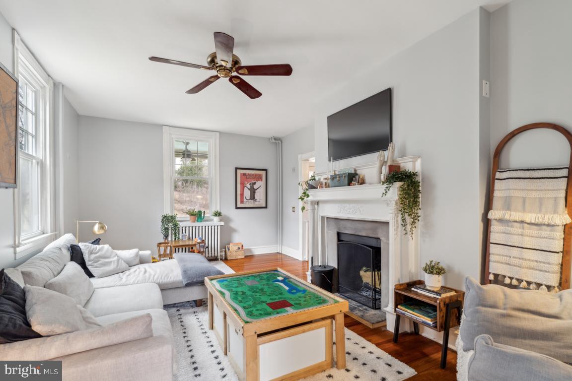 1811 Dixon Road Baltimore, MD 21209 - Photo 7 of 45 a living room with furniture a flat screen tv and a fireplace