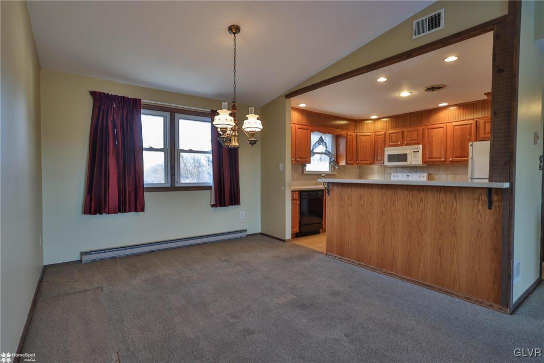 2629 Beacon Road Bath, PA 18014 - Photo 10 of 40 a view of a kitchen with a refrigerator stove cabinets and a wooden floor