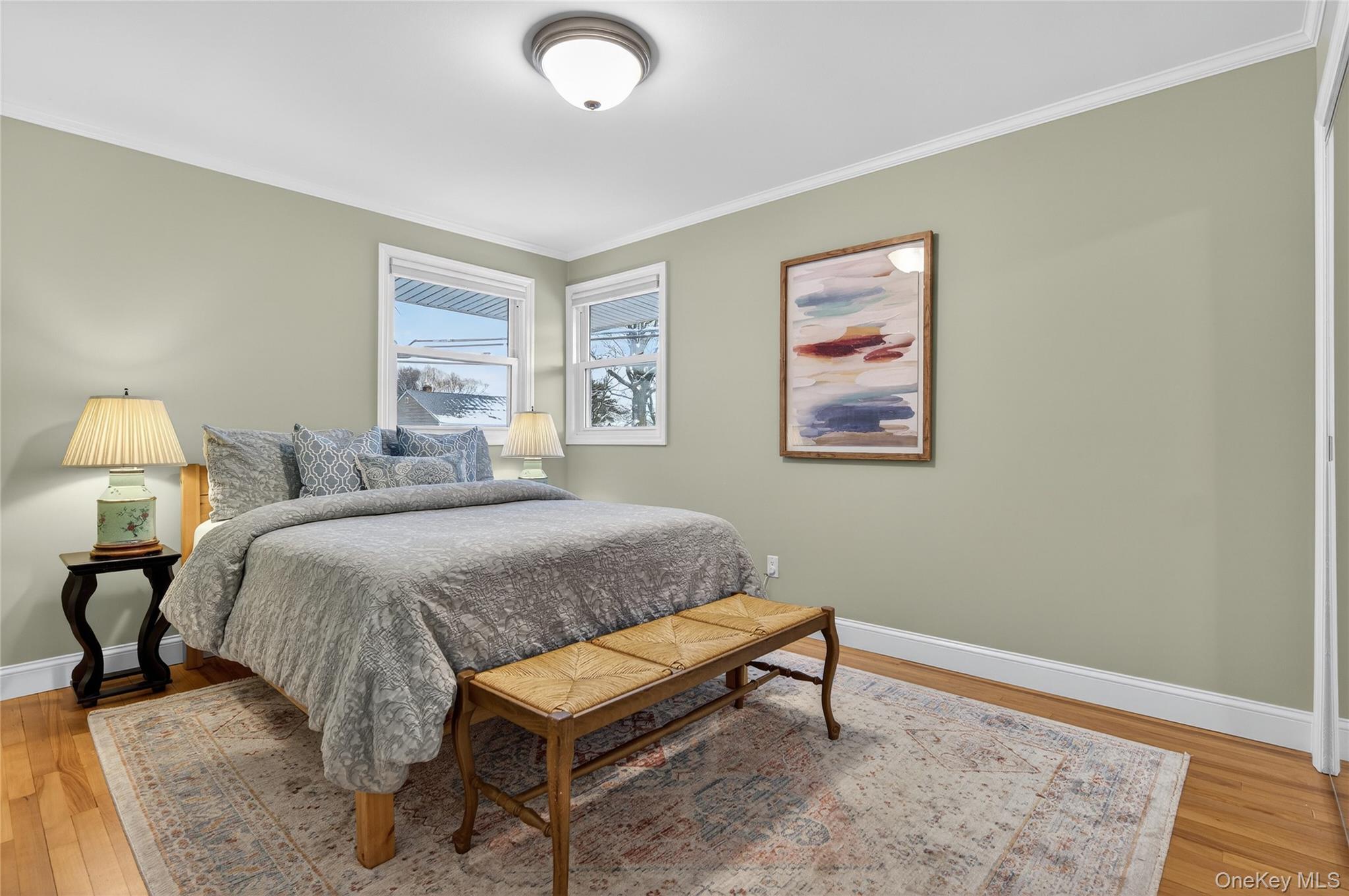 6 Dale Avenue Syosset, NY 11791 - Photo 17 of 34 a bedroom with a bed and a lamp on dresser