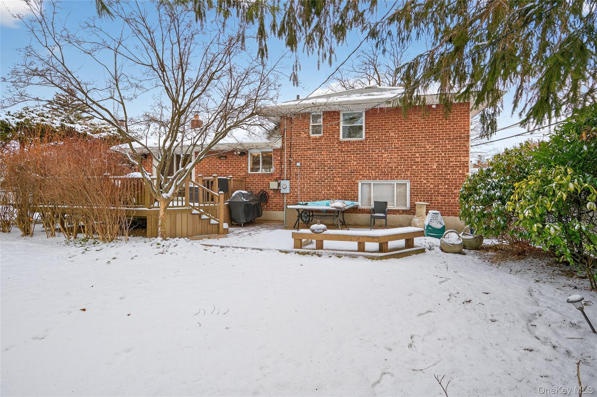 6 Dale Avenue Syosset, NY 11791 - Photo 28 of 34 a view of a house with a yard covered in snow