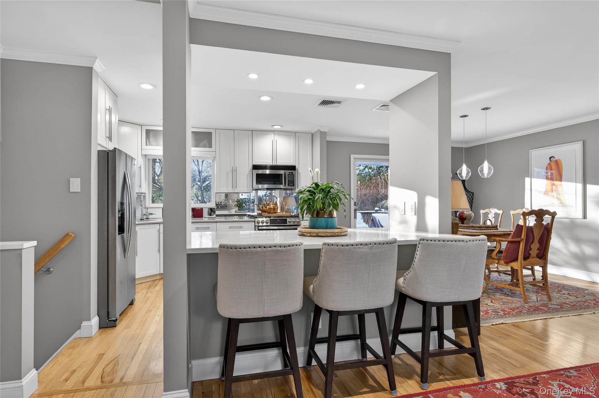 6 Dale Avenue Syosset, NY 11791 - Photo 6 of 34 a kitchen with stainless steel appliances kitchen island granite countertop a table chairs and a refrigerator