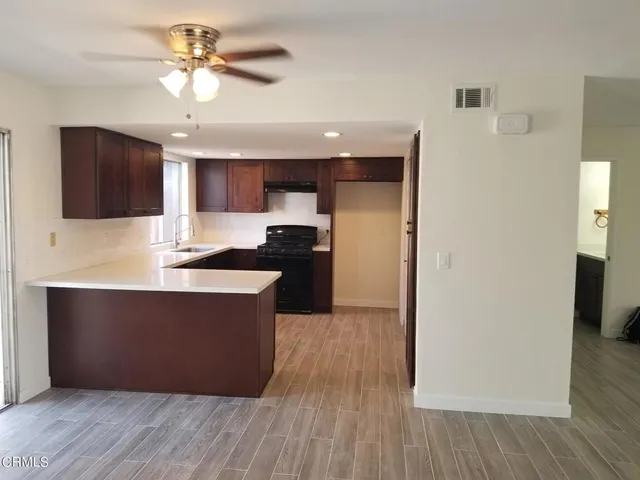 a kitchen with granite countertop a stove and a refrigerator