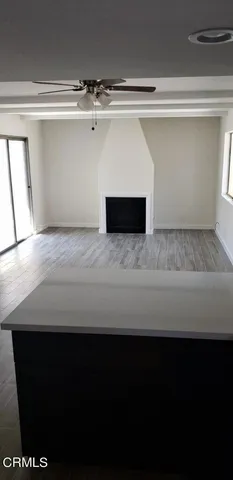 a view of water heater room with wooden floor