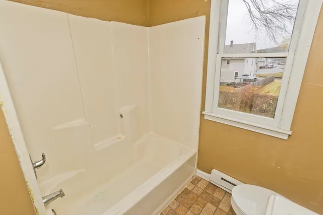 a bathroom with a bathtub and shower