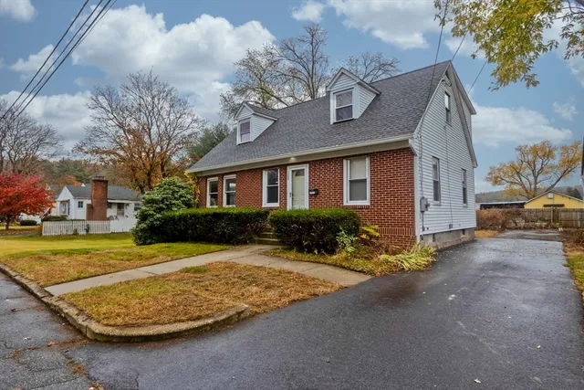 a front view of a house with a yard garage and outdoor seating
