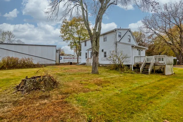a view of a patio with table and chairs under an umbrella