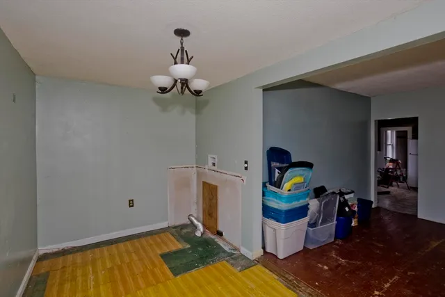 a room with stainless steel appliances kitchen island granite countertop furniture a rug and a window
