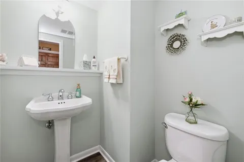 a bathroom with a sink toilet and a mirror