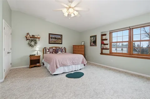 a bedroom with a bed dresser and a window