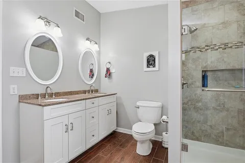 a bathroom with a toilet a sink and a mirror