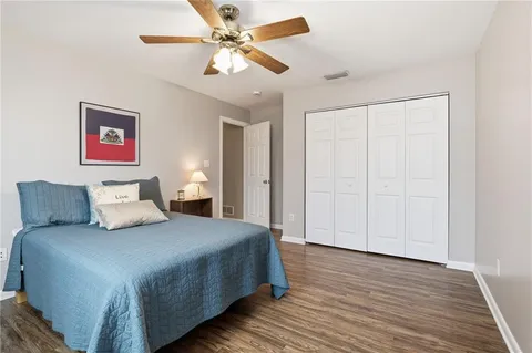 a bedroom with a large bed and a chandelier