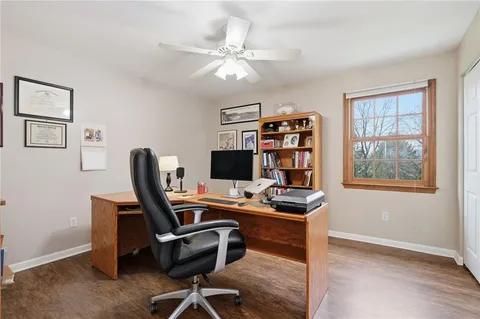 a view of a workspace with furniture and a window