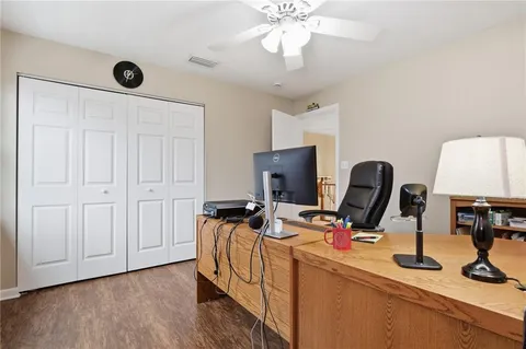 a view of a workspace with furniture and a window