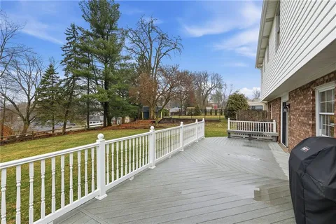 a view of a chairs and trees in the roof deck