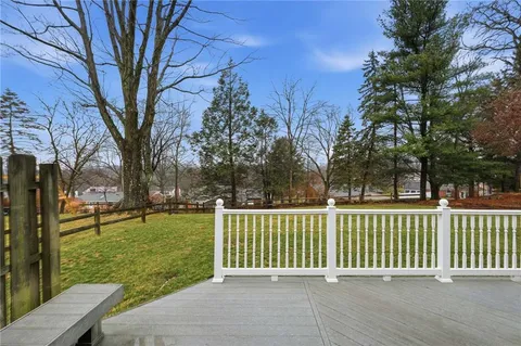a view of a house with backyard and trees