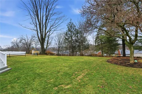 a huge green field with lots of trees