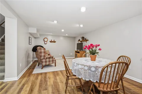 a view of a dining room with furniture and a potted plant
