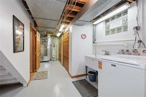 a utility room with sink dryer and washer