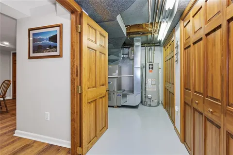 a view of a hallway with wooden shelves