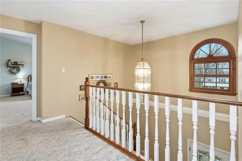 a view of a room with wooden floor windows and a chandelier
