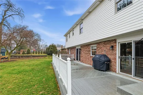 a view of a house with backyard and porch
