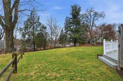 a view of a backyard with large trees