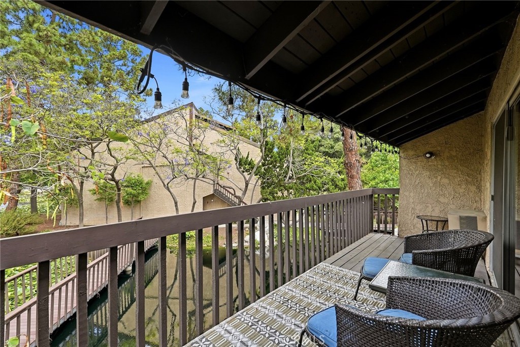 7890 East Spring Street, Unit 11E Long Beach, CA 90815 - Photo 19 of 40 a balcony with table and chairs