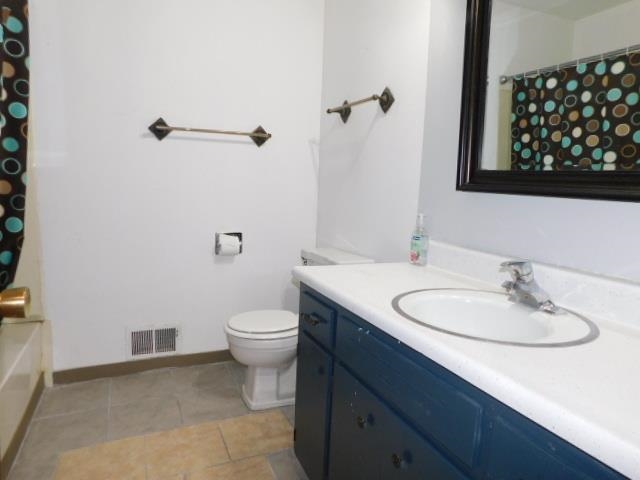 4406 Crawford Drive, Unit B Rockford, IL 61114 - Photo 13 of 15 a bathroom with a granite countertop sink toilet and mirror