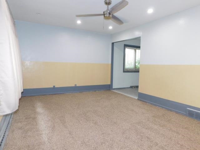 4406 Crawford Drive, Unit B Rockford, IL 61114 - Photo 4 of 15 an empty room with a empty space and a ceiling fan