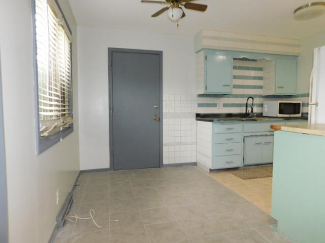 4406 Crawford Drive, Unit B Rockford, IL 61114 - Photo 5 of 15 a kitchen with granite countertop a sink and a stove top oven