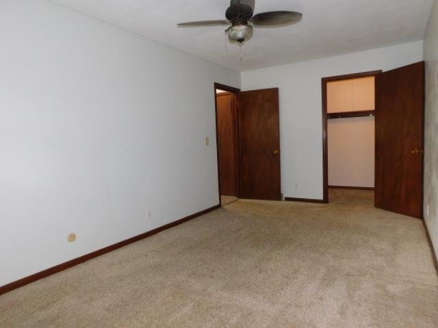 4406 Crawford Drive, Unit B Rockford, IL 61114 - Photo 9 of 15 an empty room with a window and a ceiling fan