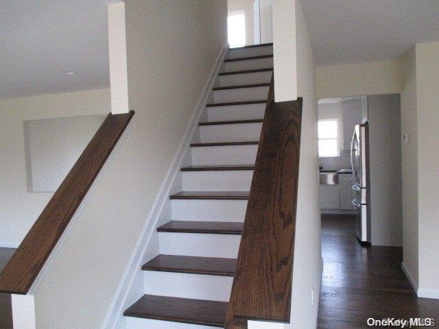 655 Bourdois Avenue Bellport, NY 11713 - Photo 14 of 28 a view of an entryway with wooden floor and stairs