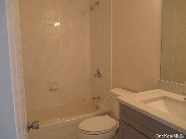 655 Bourdois Avenue Bellport, NY 11713 - Photo 15 of 28 a bathroom with a sink a toilet and shower
