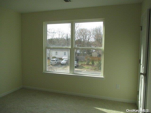 655 Bourdois Avenue Bellport, NY 11713 - Photo 17 of 28 a view of an empty room with a window