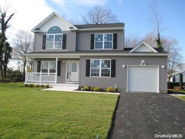 655 Bourdois Avenue Bellport, NY 11713 - Photo 2 of 28 a front view of a house with a garden and yard