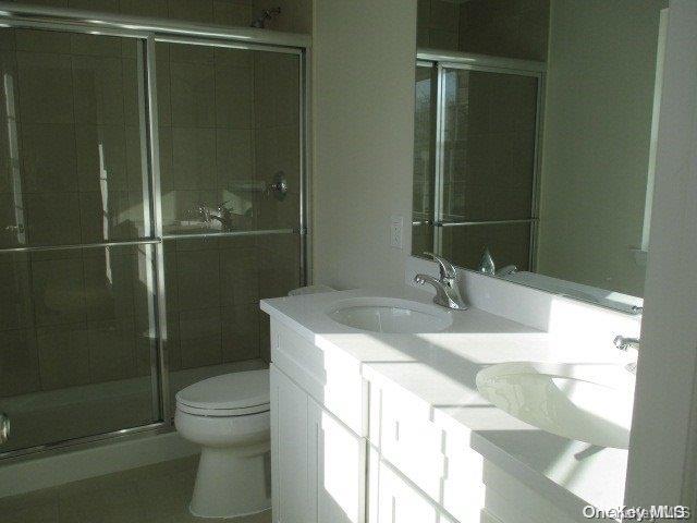 655 Bourdois Avenue Bellport, NY 11713 - Photo 27 of 28 a bathroom with a sink a toilet and shower
