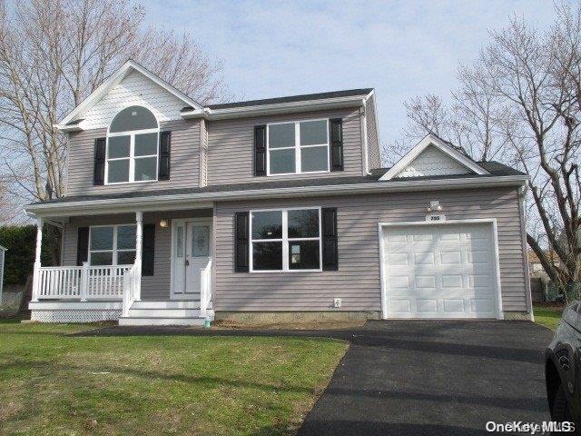 655 Bourdois Avenue Bellport, NY 11713 - Photo 6 of 28 a front view of a house with a yard