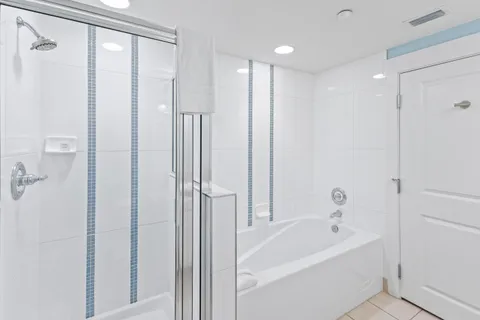 a bathroom with a bathtub and a shower