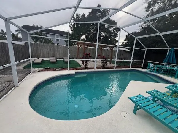 a view of a swimming pool with a yard